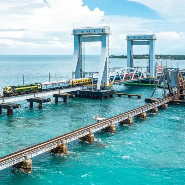 a train on a bridge over water (pamban bridge)